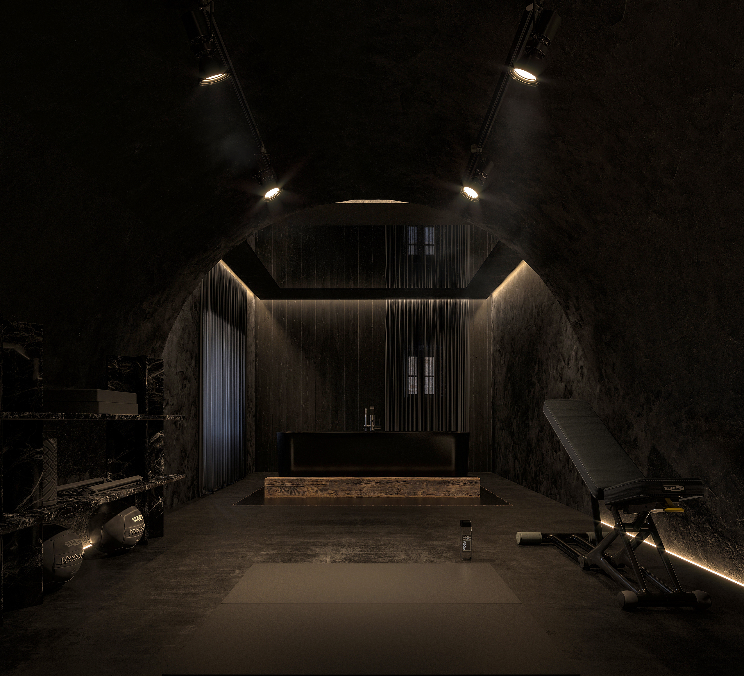 Salle de sport en cave voûtée du château de La Baume – pierre brute noire, éclairage rasant, baignoire de récupération et équipements de fitness