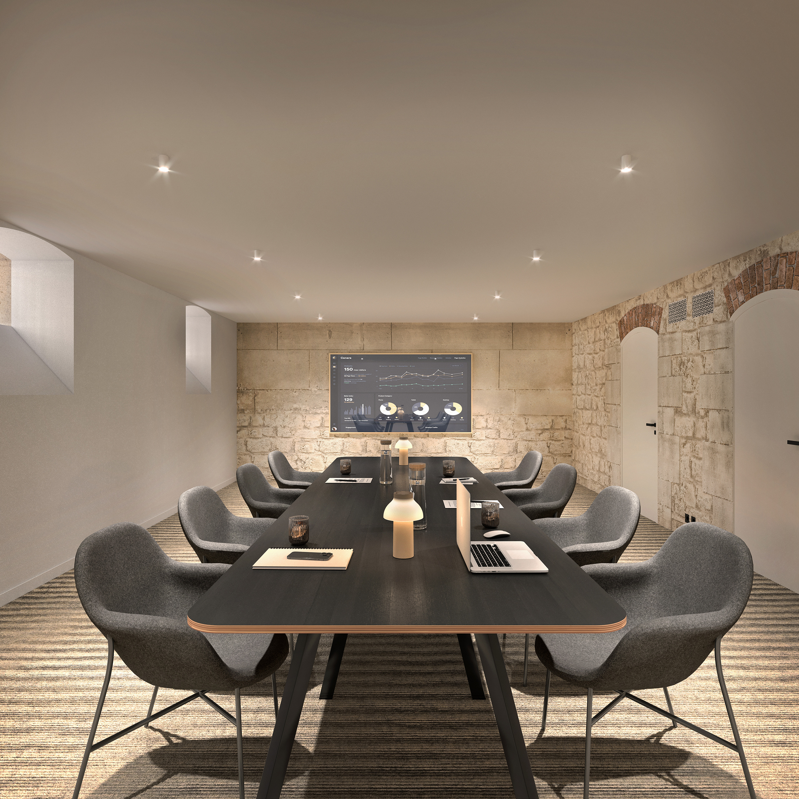 Salle de réunion en sous-sol du projet Renaissance, Miromesnil Paris. Pierre apparente, arches en brique, table de conférence noire.