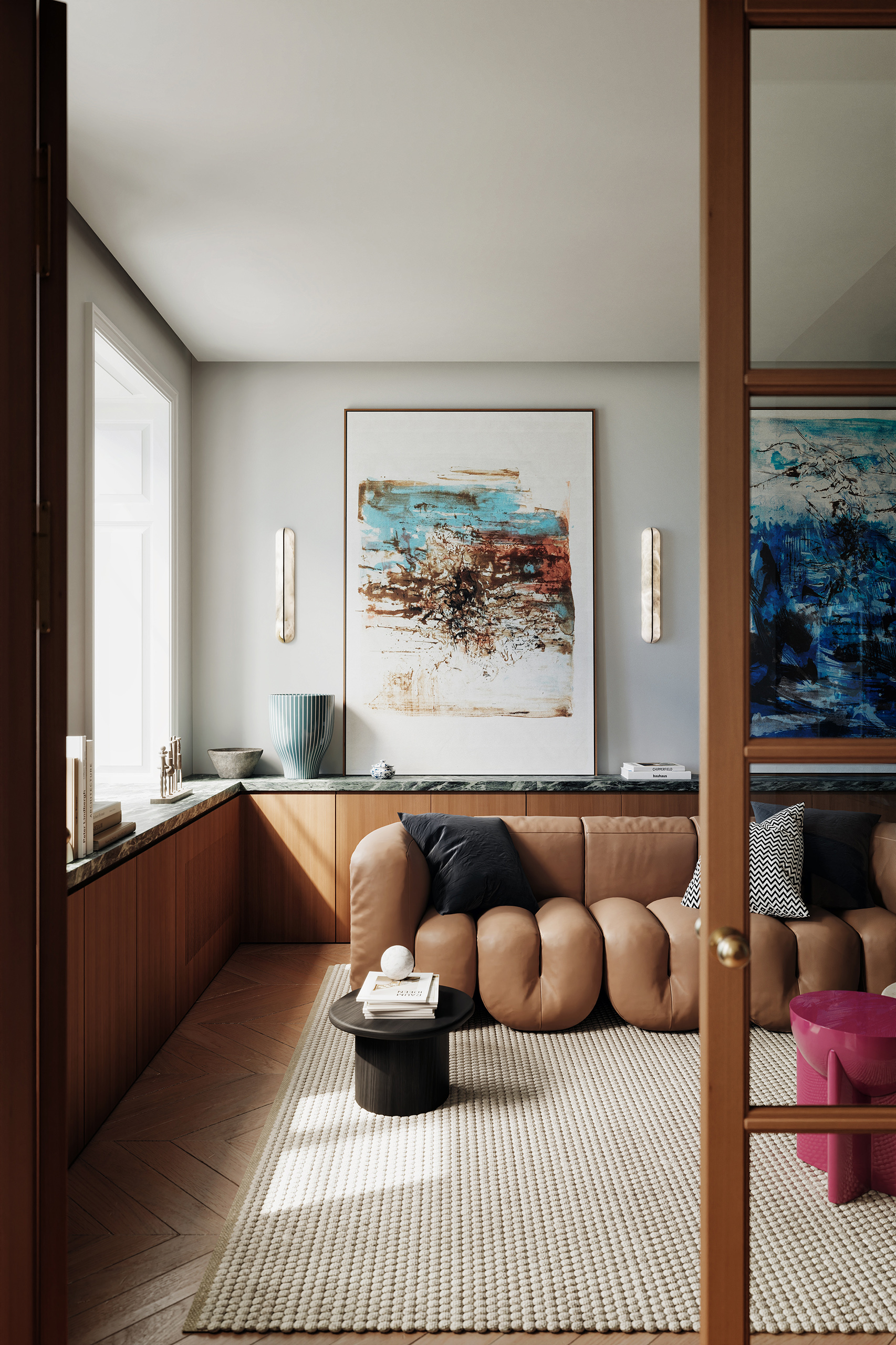 Salon Parisien, canapé modulaire en cuir cognac, bibliothèque basse en noyer et marbre vert, appliques laiton et œuvres abstraites.