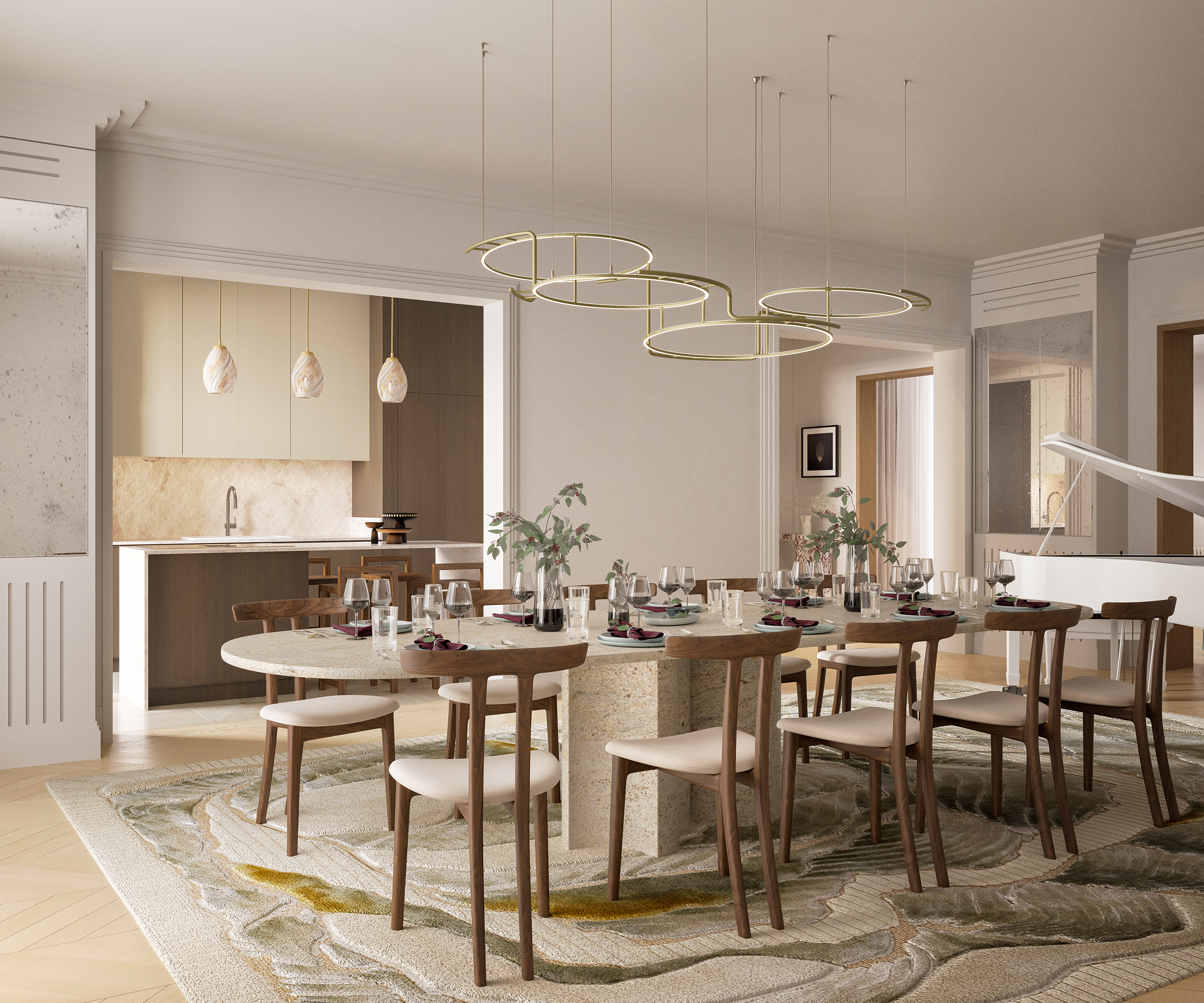 Signature – salle à manger avec grande table en travertin dressée, lustre en anneaux dorés, cuisine ouverte en arrière-plan, piano blanc à droite