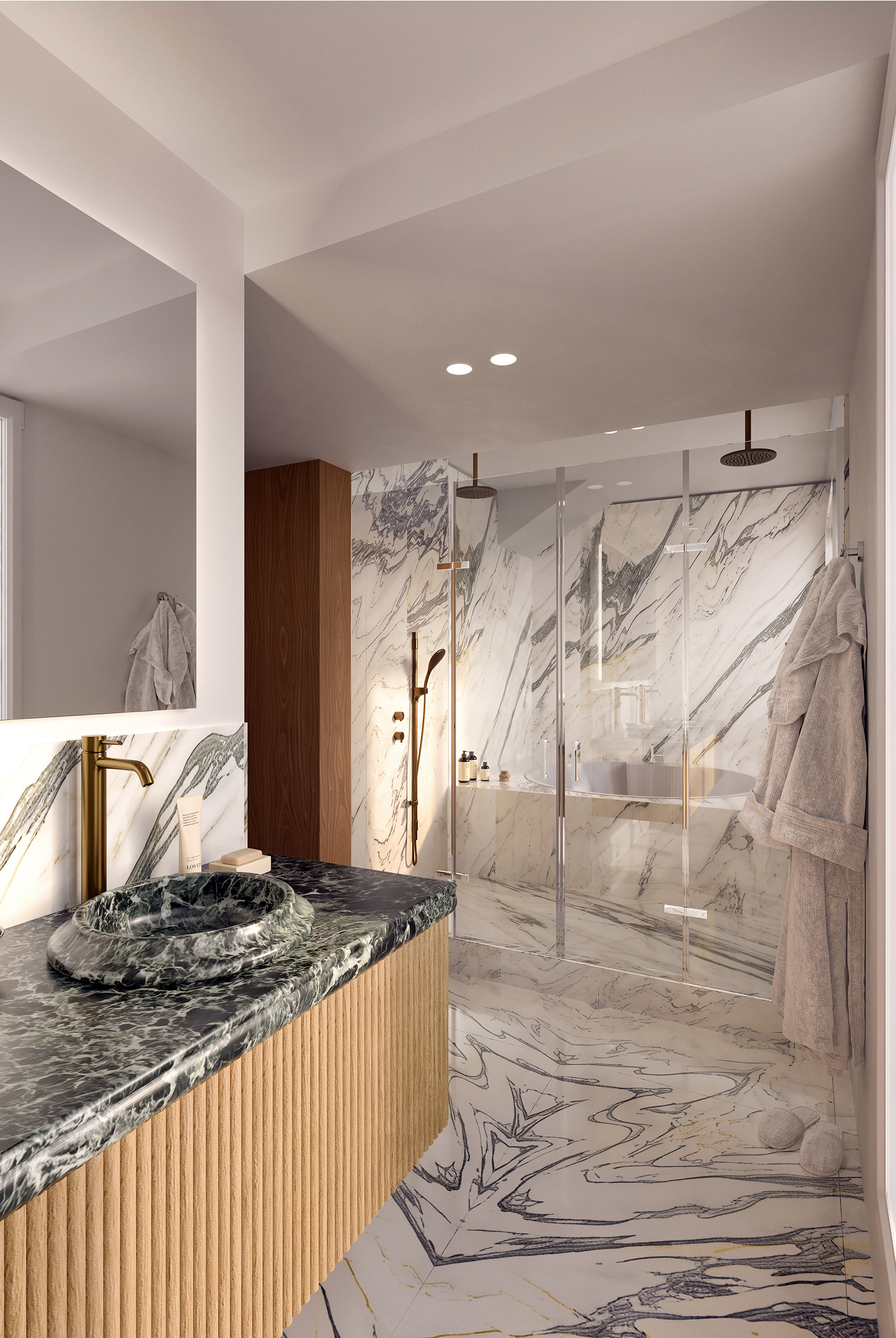 Signature – salle de bain en marbre veiné, vasque ronde en pierre verte, robinetterie dorée, douche à l'italienne vitrée, meuble en bois cannelé